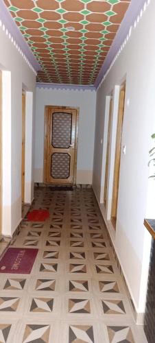 a hallway with a door and a tile floor at Sukoon Turtuk Home Stay in Turtok
