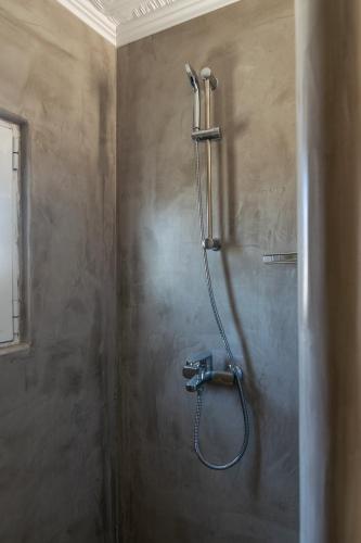 a shower in a bathroom with a shower head at Amato in Mandrakia