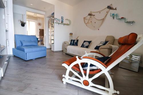 a living room with a wheelchair and a couch at Una Conchiglia sul Mare Attico vista Portofino in Zoagli