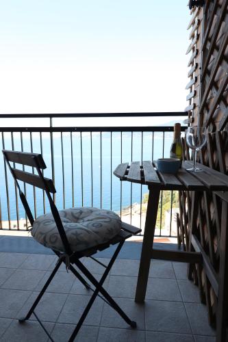 a chair sitting next to a table on a balcony at Una Conchiglia sul Mare Attico vista Portofino in Zoagli