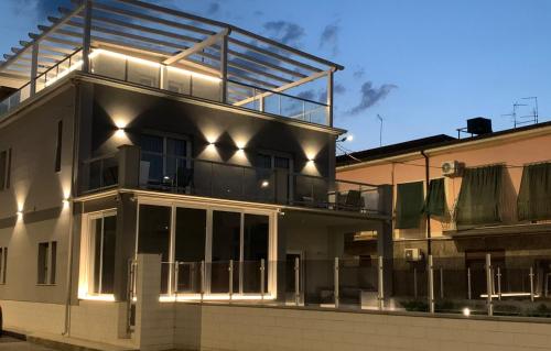 a house with a lot of windows and a balcony at Luxury House in Villapiana