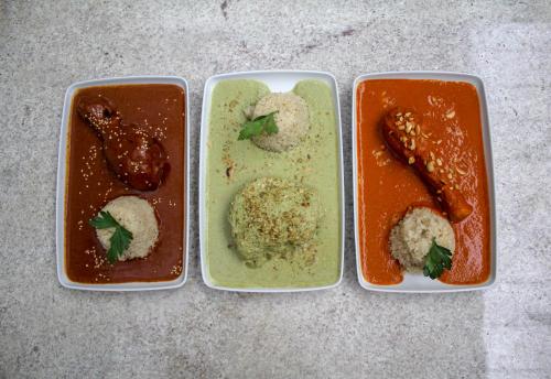 three plastic containers filled with different types of food at Hotel Boutique Casona de Santa Clara in Puebla