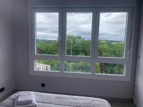a bedroom with a large window with a bed in it at lucushouse III in Lugo