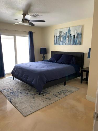 a bedroom with a bed and a ceiling fan at Newly Remodeled Family Friendly 3B/2B House in Henderson