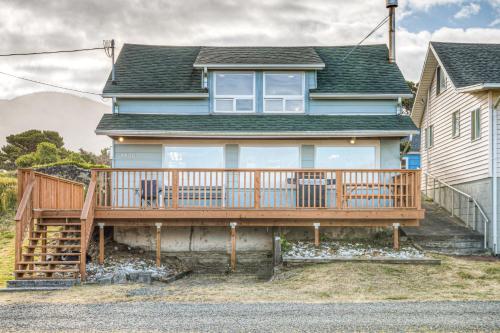 a house with a large deck on the side of it at Elbow's Inn in Rockaway Beach
