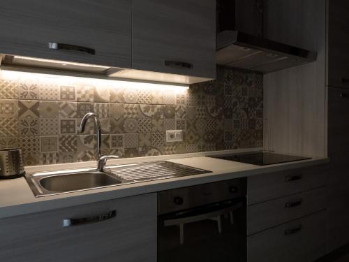 a kitchen with a sink and a counter top at Appartamento Casa Azzurra in Porto San Giorgio