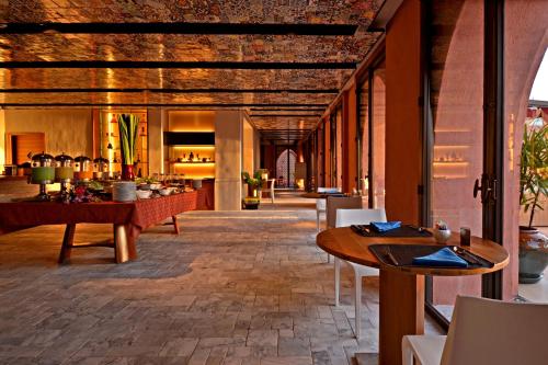 a restaurant with wooden ceilings and tables and chairs at Marrakesh Hua Hin Resort & Spa in Hua Hin