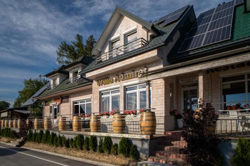 a house with solar panels on the side of it at Willa Admirał Solina in Solina