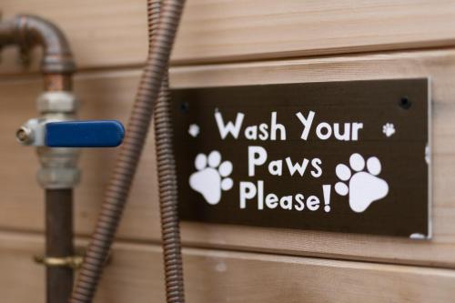 a sign that reads wash your paws please at Cedar Cottage in Tenby