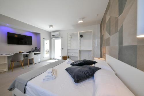 a bedroom with a large white bed with two pillows at Fortino Uno in Ischia