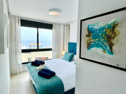 a bedroom with a bed and a large window at Beach Paradise in Fuengirola in Fuengirola