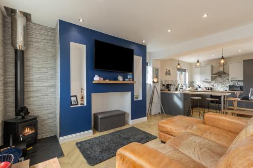 a living room with a couch and a fire place at Hazel Cottage in Tenby