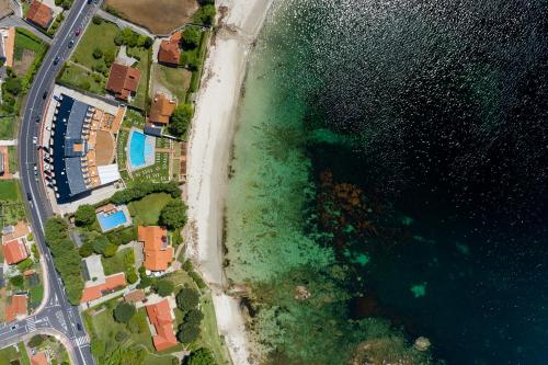 an aerial view of a beach and the ocean at Hotel Spa Nanin Playa in Sanxenxo
