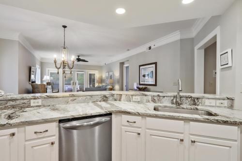 a kitchen with a marble counter top and a sink at 8121 Wendover Dunes in Hilton Head Island