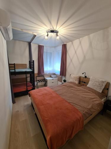 a bedroom with a large bed with a ceiling at EDA Beach Galerius Apartman in Siófok
