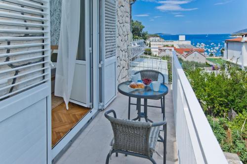 a small table on the balcony of a house at Hvar Deluxe Rooms in Hvar