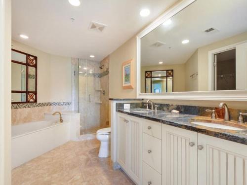 a bathroom with two sinks and a toilet and a shower at 6405 Hampton Place in Hilton Head Island
