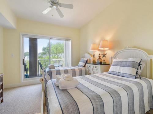 two beds in a room with a window at 6405 Hampton Place in Hilton Head Island