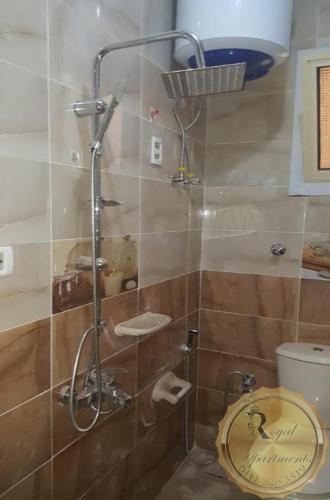 a shower stall in a bathroom with a toilet at Royal Apartments in Matrouh in Marsa Matruh