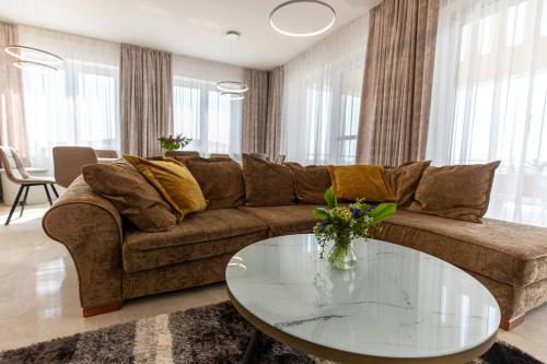 a living room with a couch and a glass table at Aszúvilág Rezidencia with Sauna & Jacuzzi in Legyesbénye