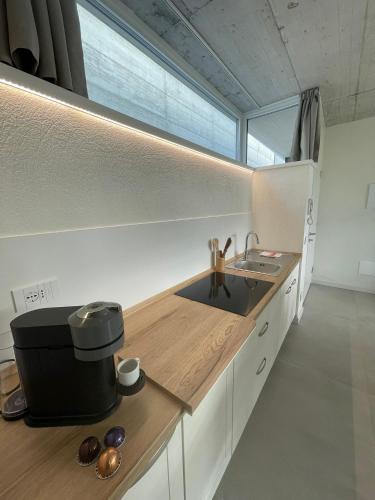 a kitchen with a counter with a sink and a window at Guendalina Suite 2 in Verona