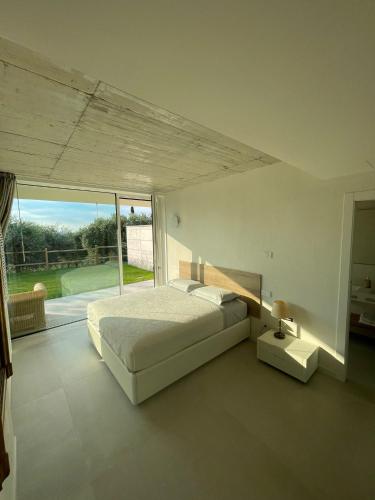 a bedroom with a bed and a large window at Guendalina Suite 2 in Verona