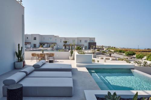 a patio with a pool and a table and chairs at Lilium Homes in Karterados