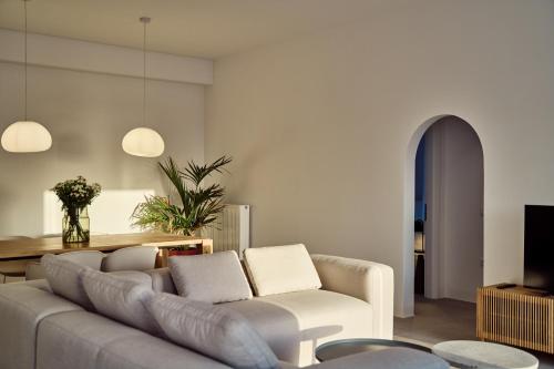 a living room with a couch and a table at Lilium Homes in Karterados
