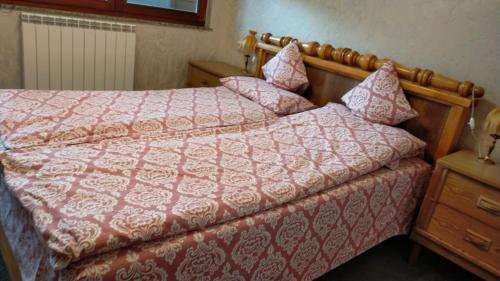 a bedroom with a bed with a red comforter at Casa Irimescu in Gura Humorului