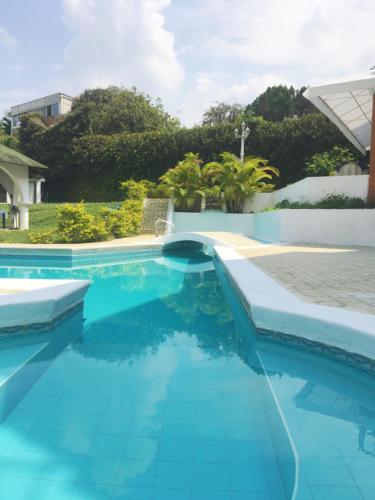 a swimming pool with blue water in a house at Hostal Mallorca Boutique in Cali