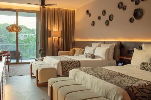 a hotel room with two beds and a balcony at Secrets Bahia Mita Surf and Spa - All Inclusive - Adults Only in Punta Mita