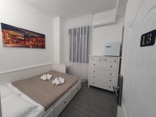a bedroom with a bed with three pillows on it at Camere Fiera Verona - CasaNostra in Verona