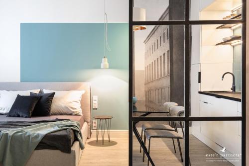 a bedroom with a bed and a table and a chair at White Boat Apartment BLUE in Budapest