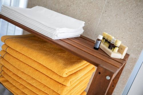 a table with towels and essential oils on it at Aszúvilág Rezidencia with Sauna & Jacuzzi in Legyesbénye