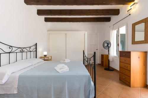 a bedroom with a bed and a dresser in a room at Holiday Home - Son Vida in Mahón