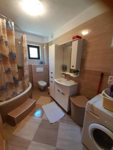 a bathroom with a tub and a sink and a toilet at Kuća za odmor Panorama Lohovo Bihać in Bihać