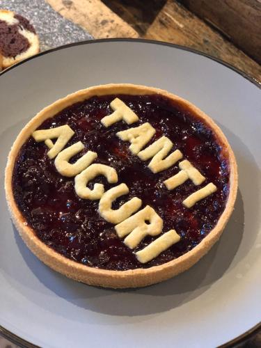 a pie with blackberry sauce and cheese on a plate at B&B Il Tabià in Pieve di Cadore