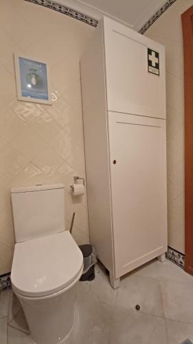 a bathroom with a white toilet in a room at Quinta Velha 22 in Tavira