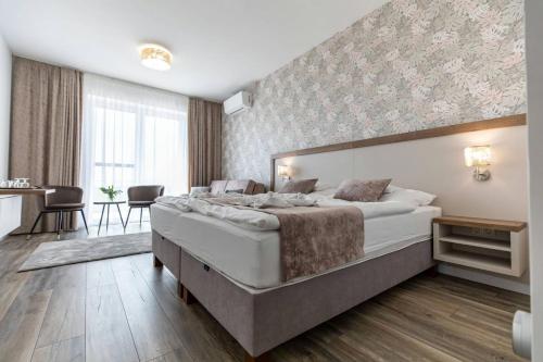 a bedroom with a large bed in a room at Aszúvilág Rezidencia with Sauna & Jacuzzi in Legyesbénye