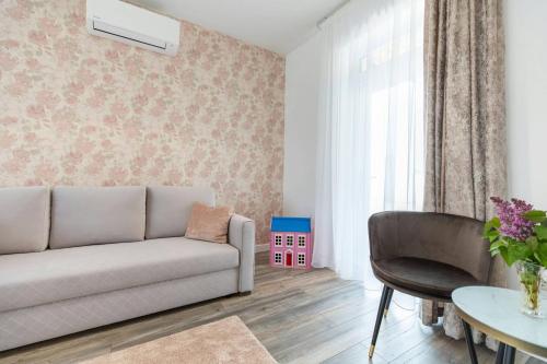 a living room with a couch and a table at Aszúvilág Rezidencia with Sauna & Jacuzzi in Legyesbénye