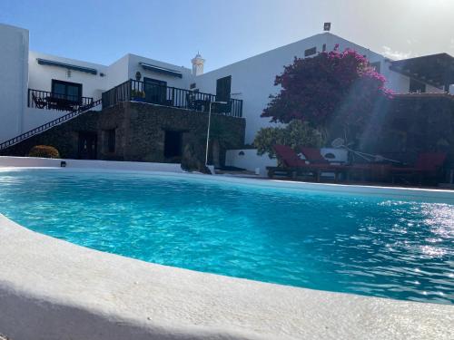 a swimming pool in front of a house at Casa Camelio in Mácher