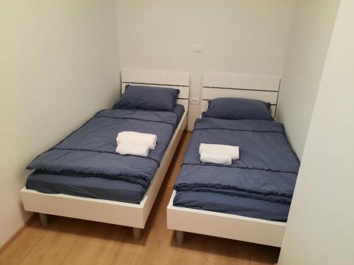 two beds sitting next to each other in a room at Bellevue 1 in Izola