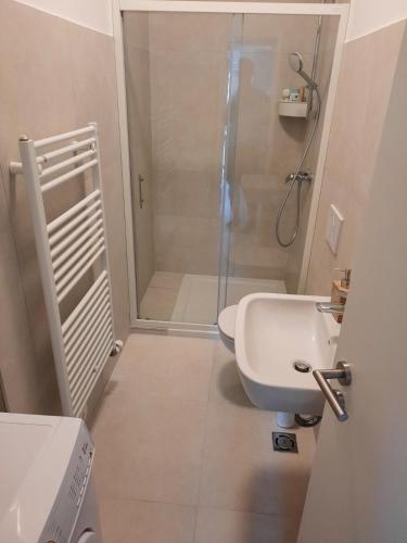 a bathroom with a shower and a toilet and a sink at Bellevue 1 Apartments in Izola