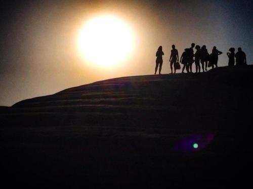 a group of people standing on a hill at sunset at B&B Villa Eleonora in Realmonte