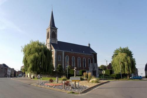 a large red brick church with a steeple at B&B Opus35 in Montzen