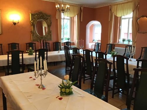 a room with long tables and chairs in it at Gutshaus Darsikow in Darsikow
