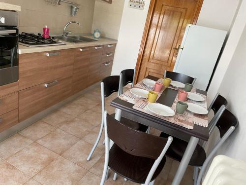 a kitchen with a table with plates and cups on it at Il trullo di nonno Licchio in Alberobello