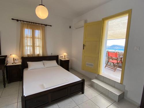 a bedroom with a bed and a window with a view at Archipelagos Boutique Hotel in Schinoussa