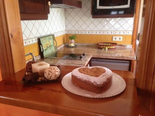 a cake sitting on a counter in a kitchen at Les Piperes in Corao