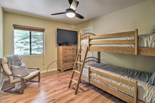 a room with two bunk beds and a tv at Patio, Fenced Yard Pet-Friendly Pinetop Cabin! in Indian Pine